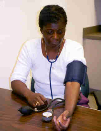 picture of the woman placing blood pressure meter where she can read it