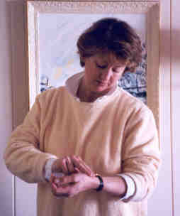 Picture of a woman looking at her watch while feeling for her pulse
