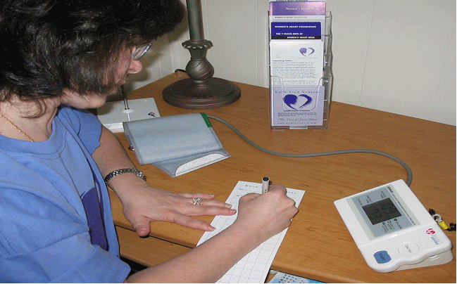  young woman with digital blood pressure device 