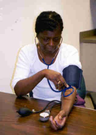 picture of the woman placing stethoscope ear pieces into her ears
