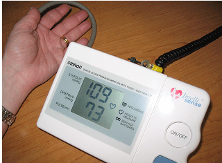  young woman with digital blood pressure device 